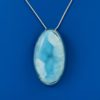 Oval shapen light and pale blue larimar stone pendant set in silver