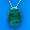 Green malachite with horizontal banding oval stone set in silver necklace