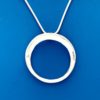 Silver necklace in the shape of a circle with beveled detail