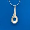 Pendant necklace in silver shaped like a large spoon with a hole in the middle of it