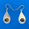 Round stones of shiny brown banded tiger eye set in flat silver teardrop shaped earrings attached to silver ear wires